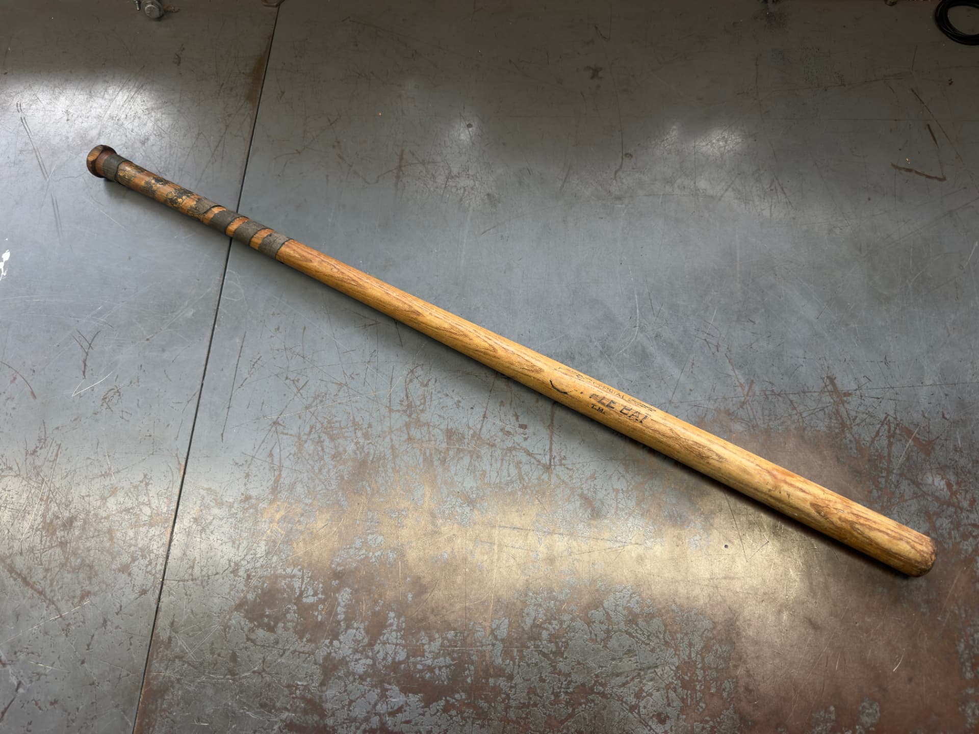 An original wooden Official Wiffle Bat with a taped handle