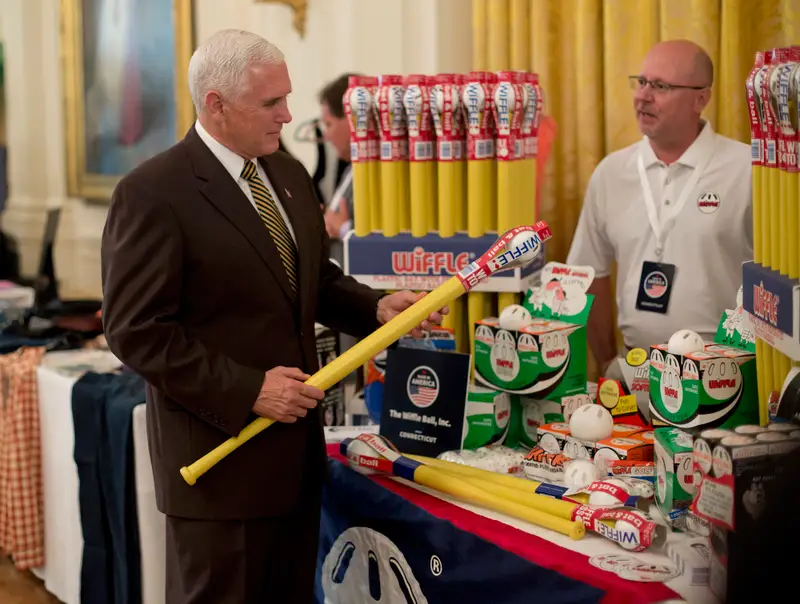 Vice President Mike Pence holding a yellow Wiffle bat at the Wiffle Ball display