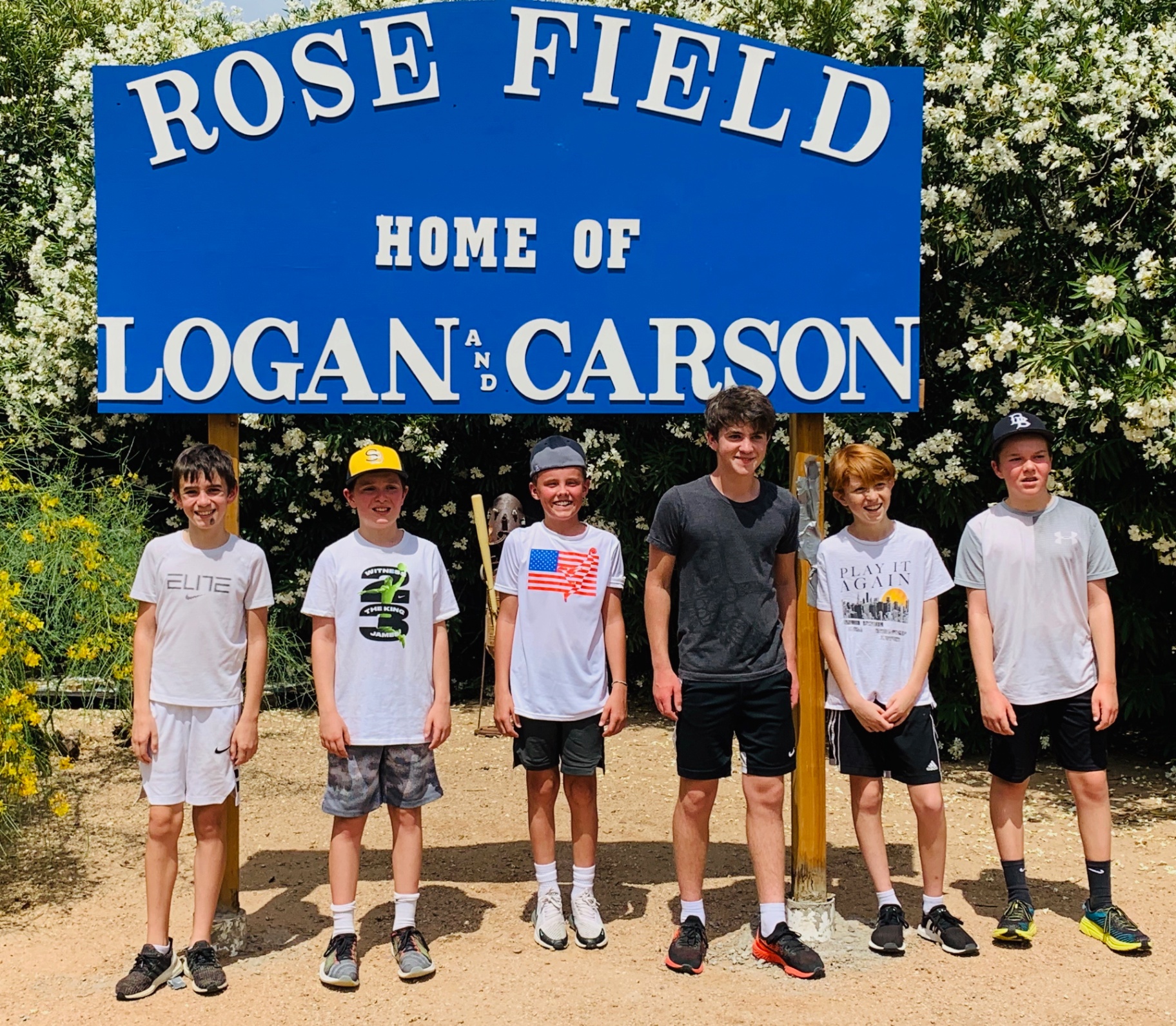 Players under the Rose Field sign